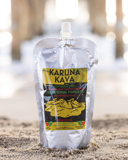 Karuna Kava package on a sandy surface with blurred natural background